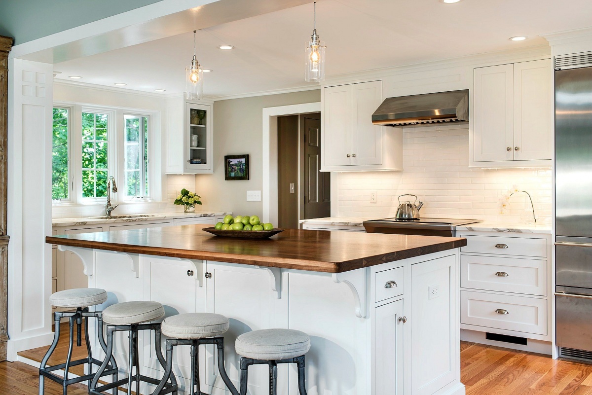 beautiful white kitchen with natural wood island top